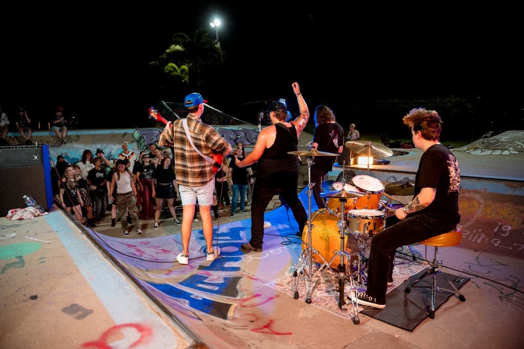 Band performing facing the crowd in the skate bowl