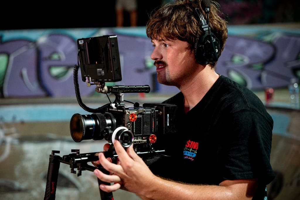 Camera operator framing a shot during the Crashing Down shoot