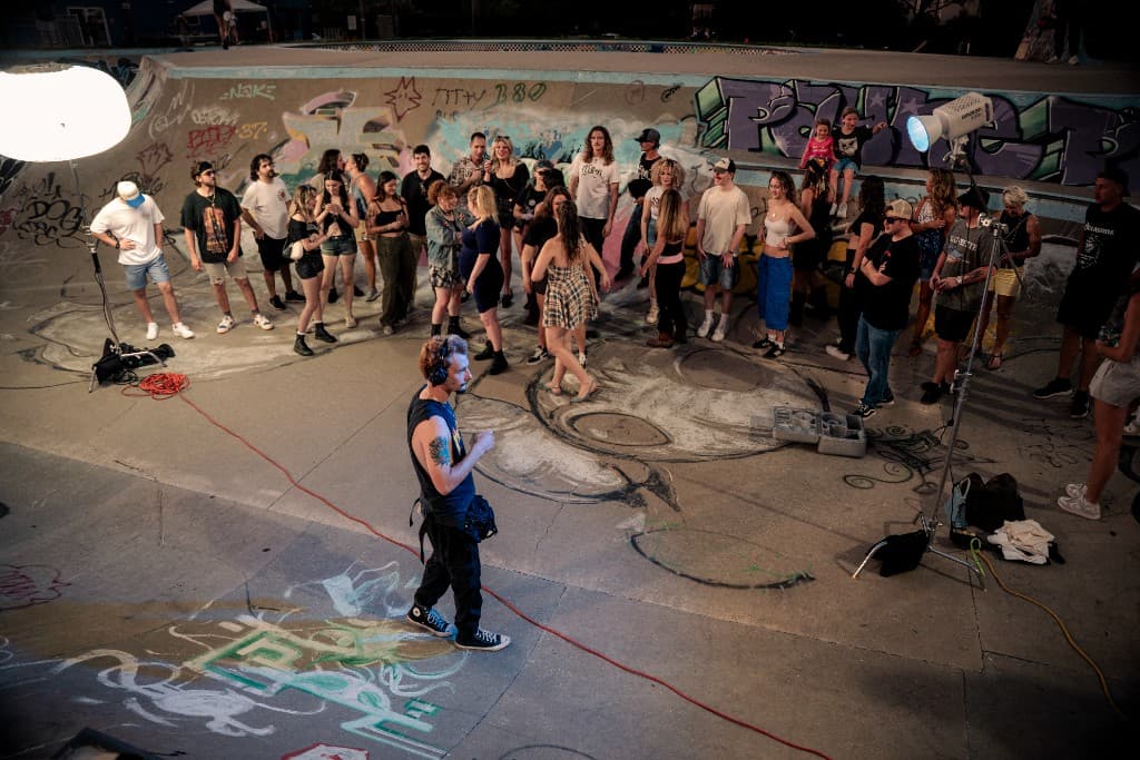 Full cast and crew gathered in the lit skate bowl