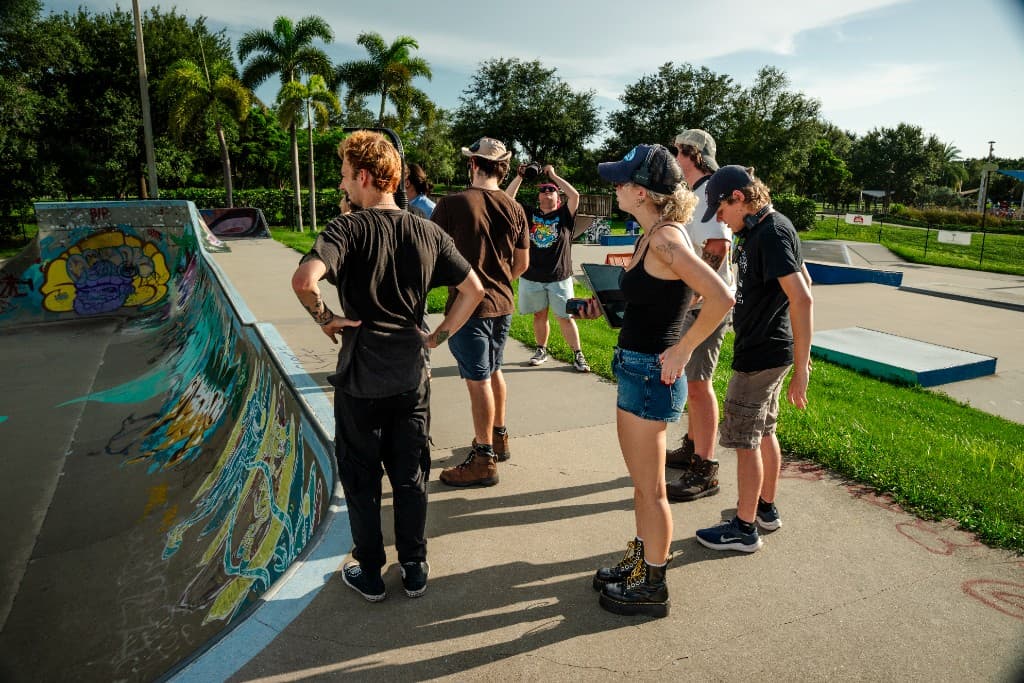 Crew reviewing footage at the skatepark during daytime