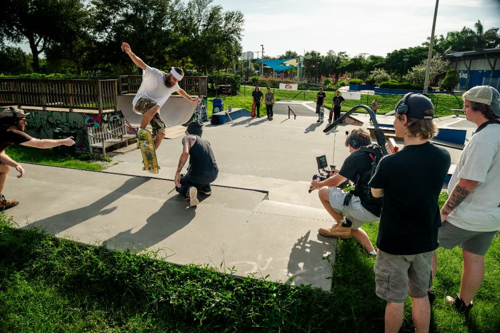 Crew capturing a skateboarder in mid-air at the park